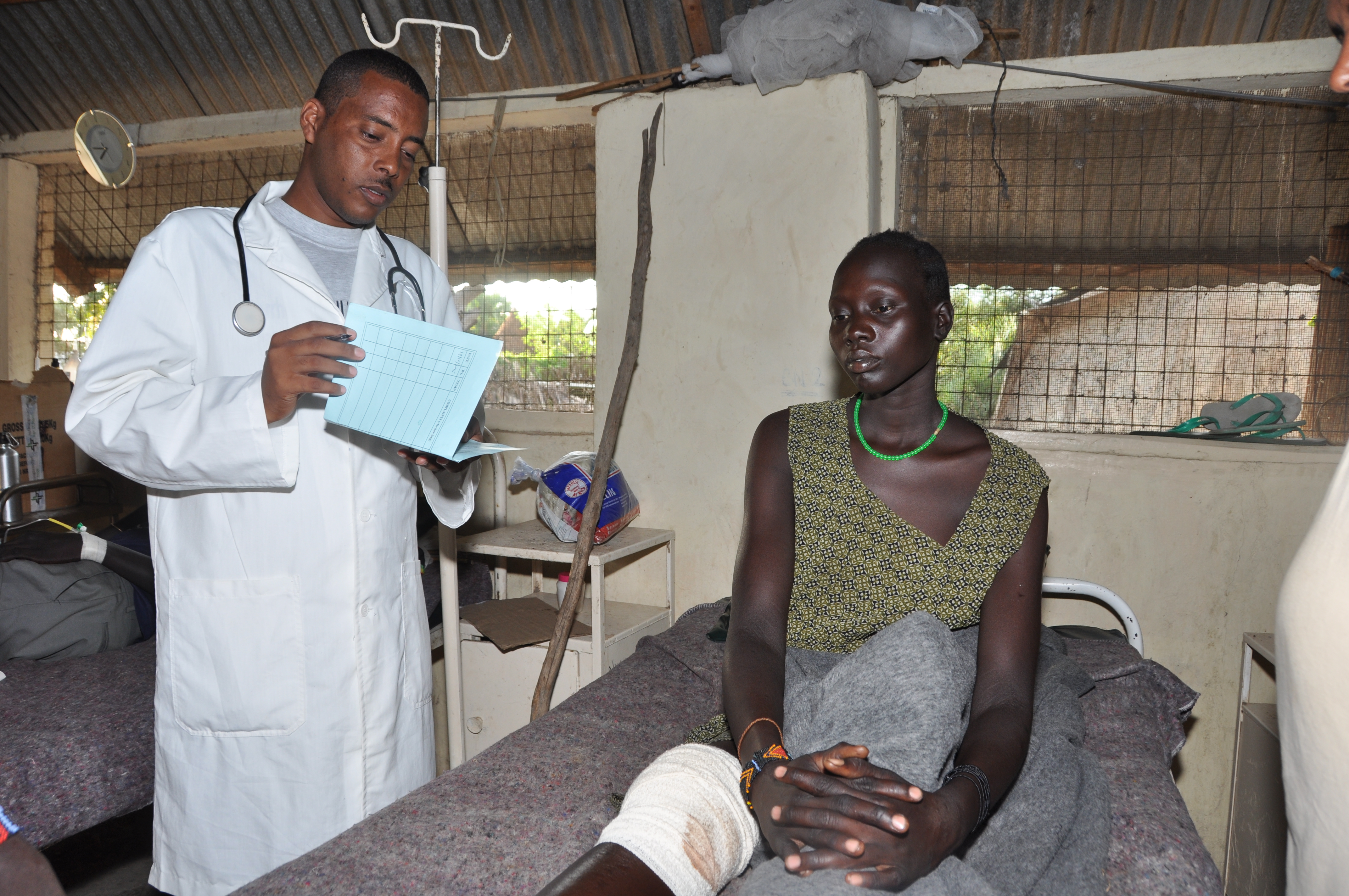This woman has suffered an injury to her knee. She can be treated as an inpatient for a few days in the infirmary of Sign of Hope. The medic on duty checks on her every morning. This woman has suffered an injury to her knee. She can be treated as an inpatient for a few days in the infirmary of Sign of Hope. The medic on duty checks on her every morning.